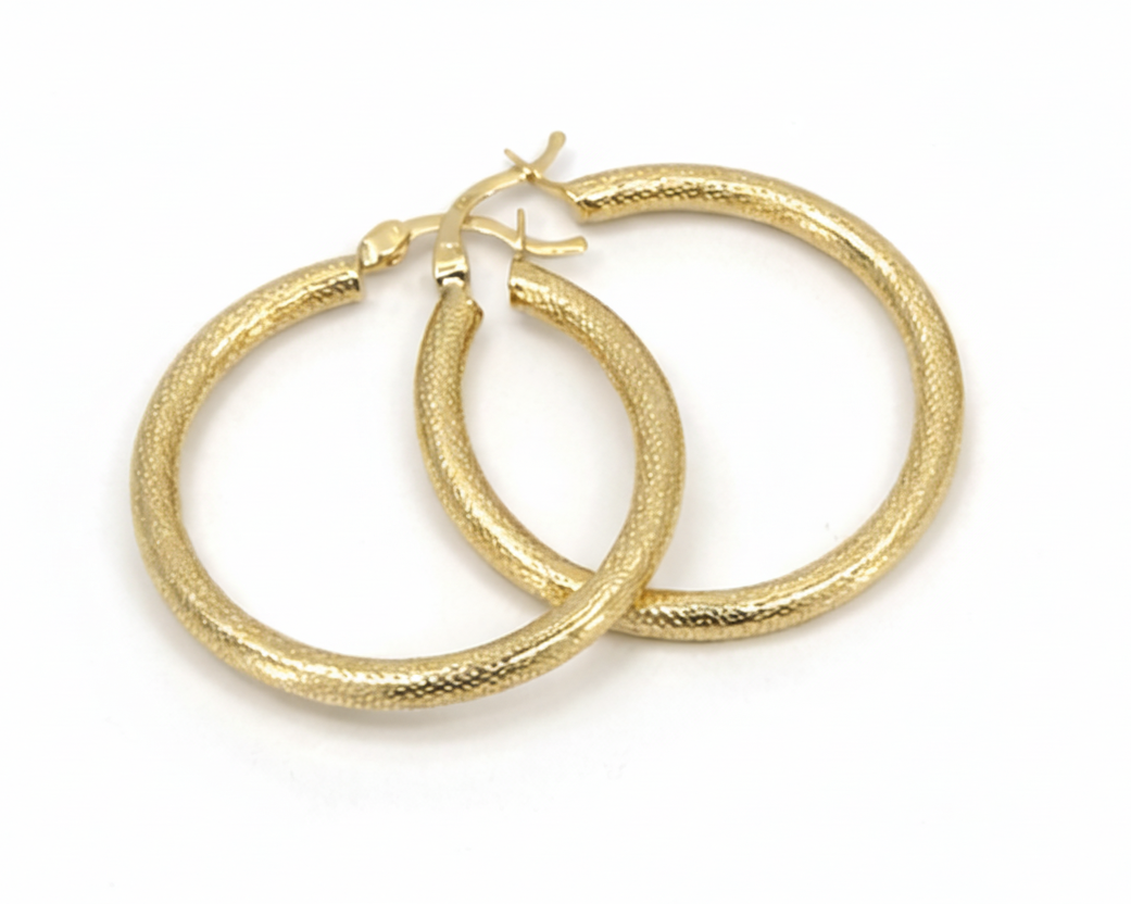Pair of gold hoop earrings on a white background