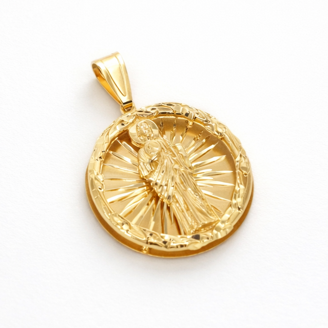 Gold pendant with a religious design on a white background