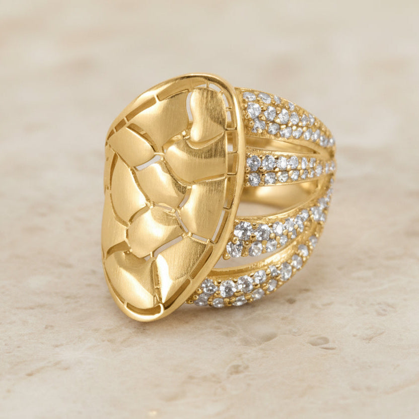 Gold ring with a unique design on a white background