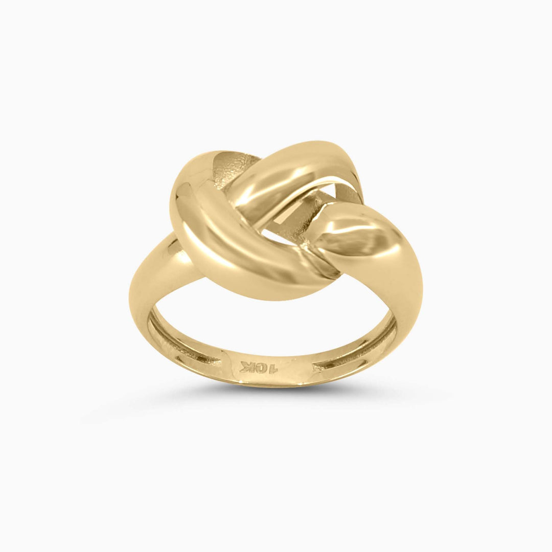 Gold ring with a knot design on a white background