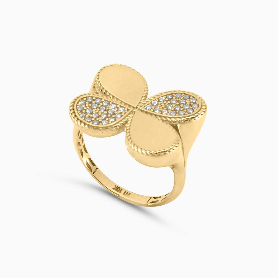 Gold ring with a butterfly design on a white background