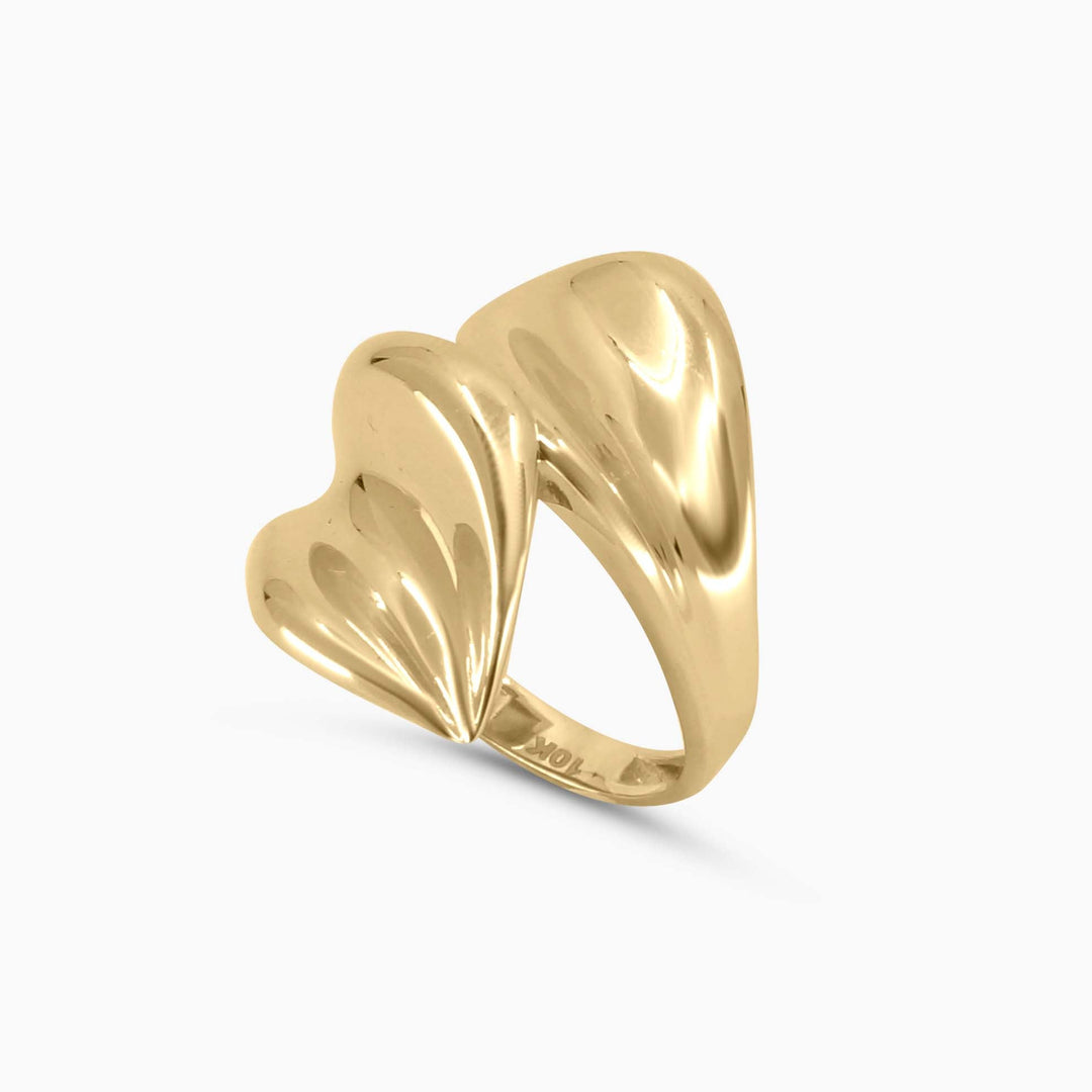 Gold ring with a wavy design on a white background