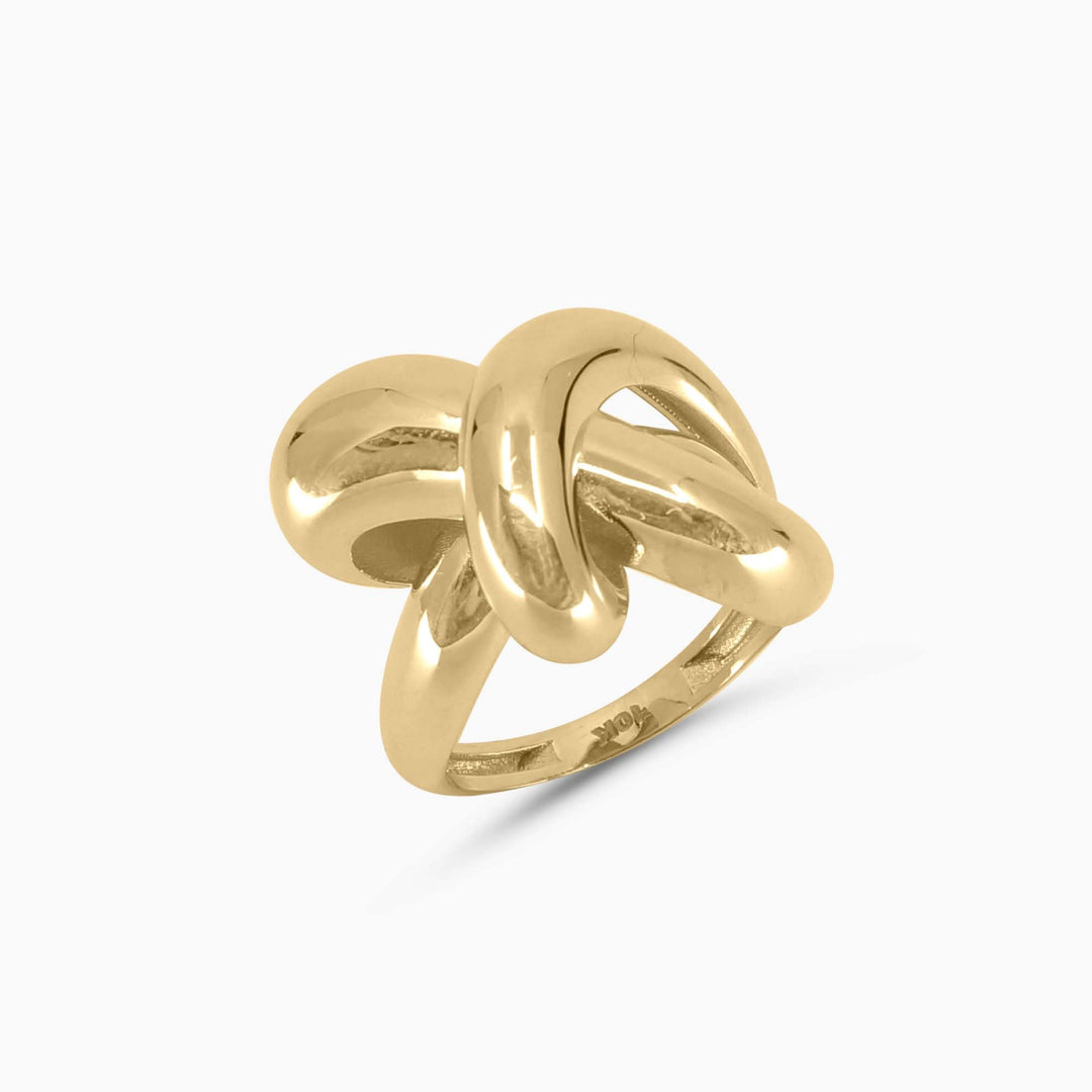 Gold knot ring on a white background