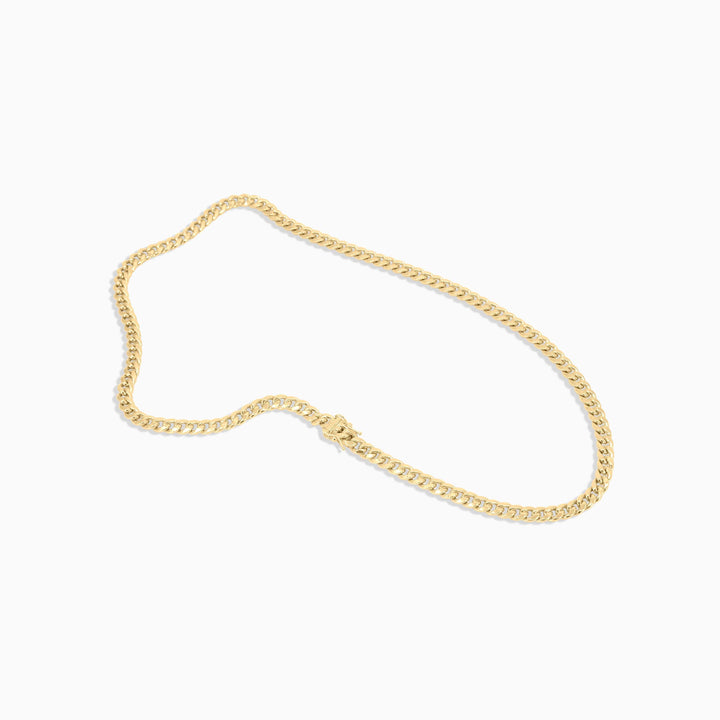 Gold chain bracelet on a white background