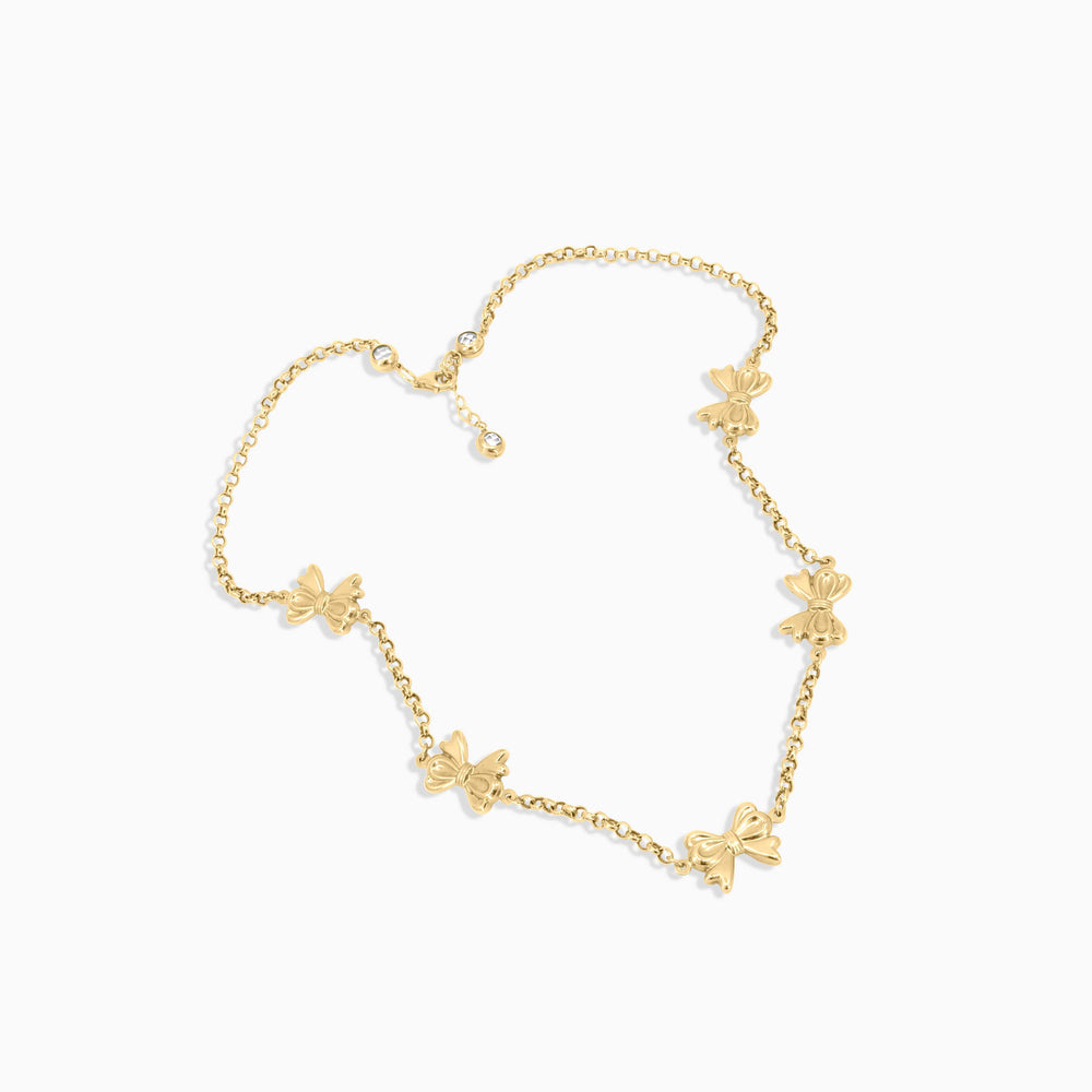 Gold butterfly necklace on a white background