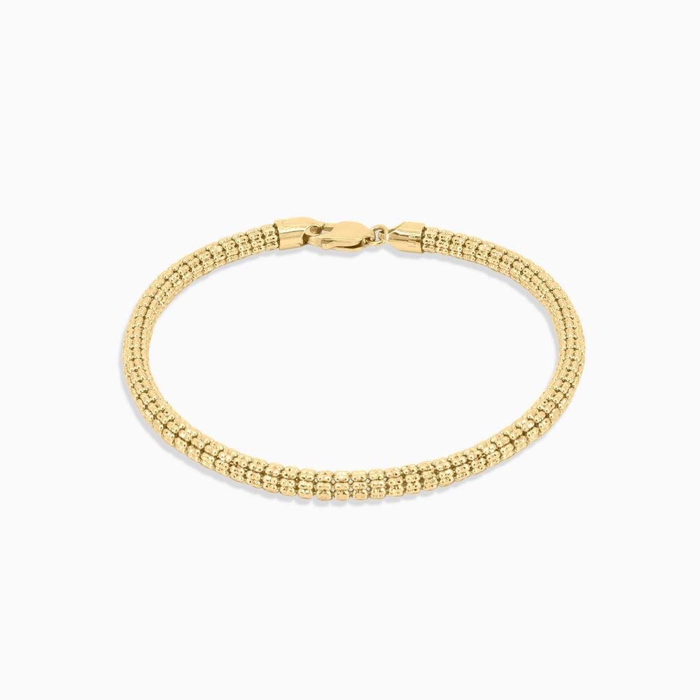 Gold bracelet on a white background