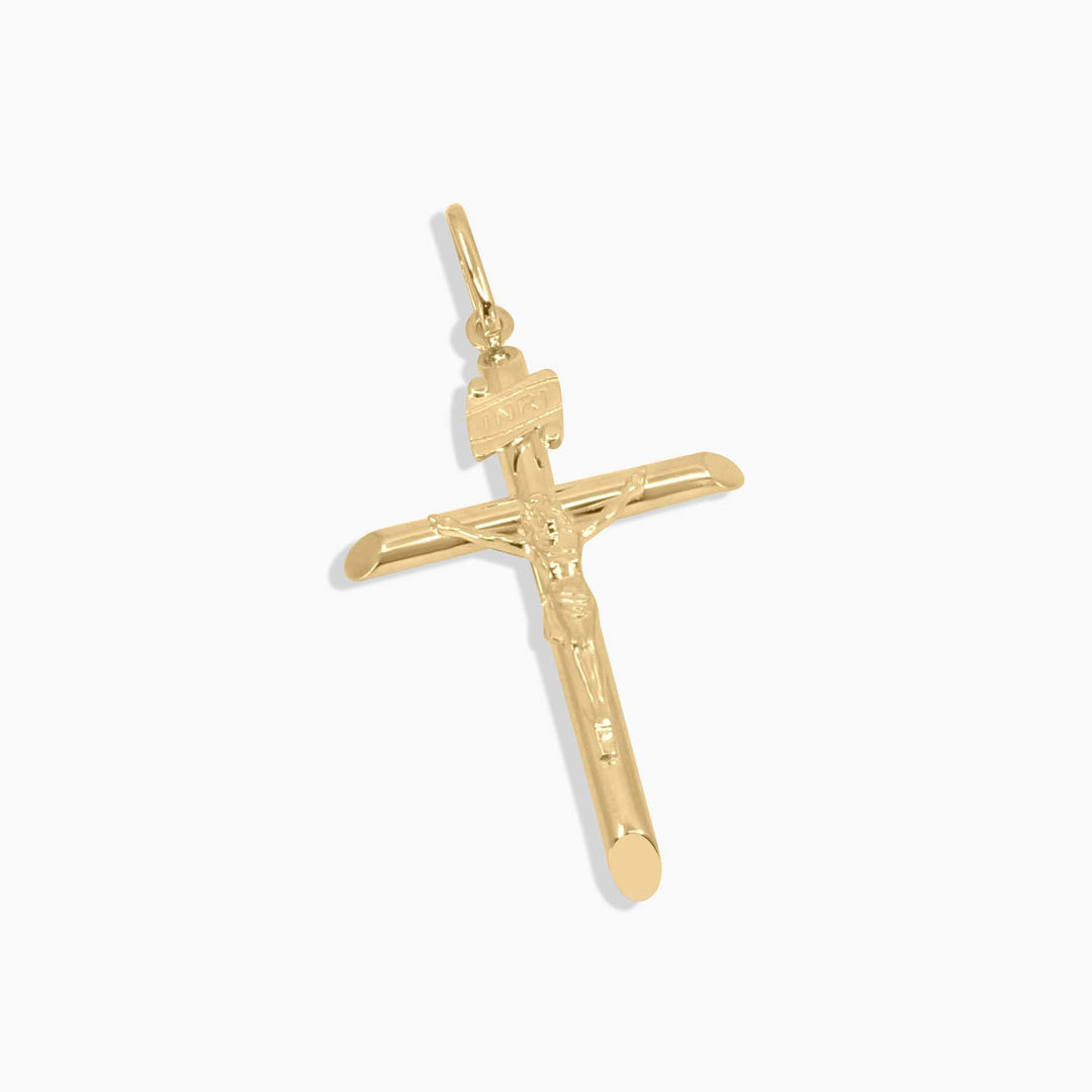 Gold cross pendant on a white background
