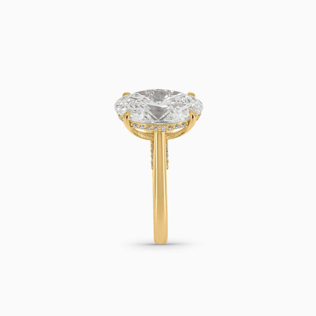 Gold ring with a clear gemstone on a white background