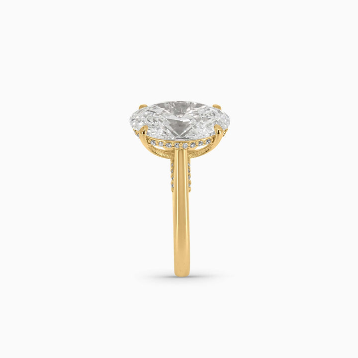 Gold ring with a clear gemstone on a white background