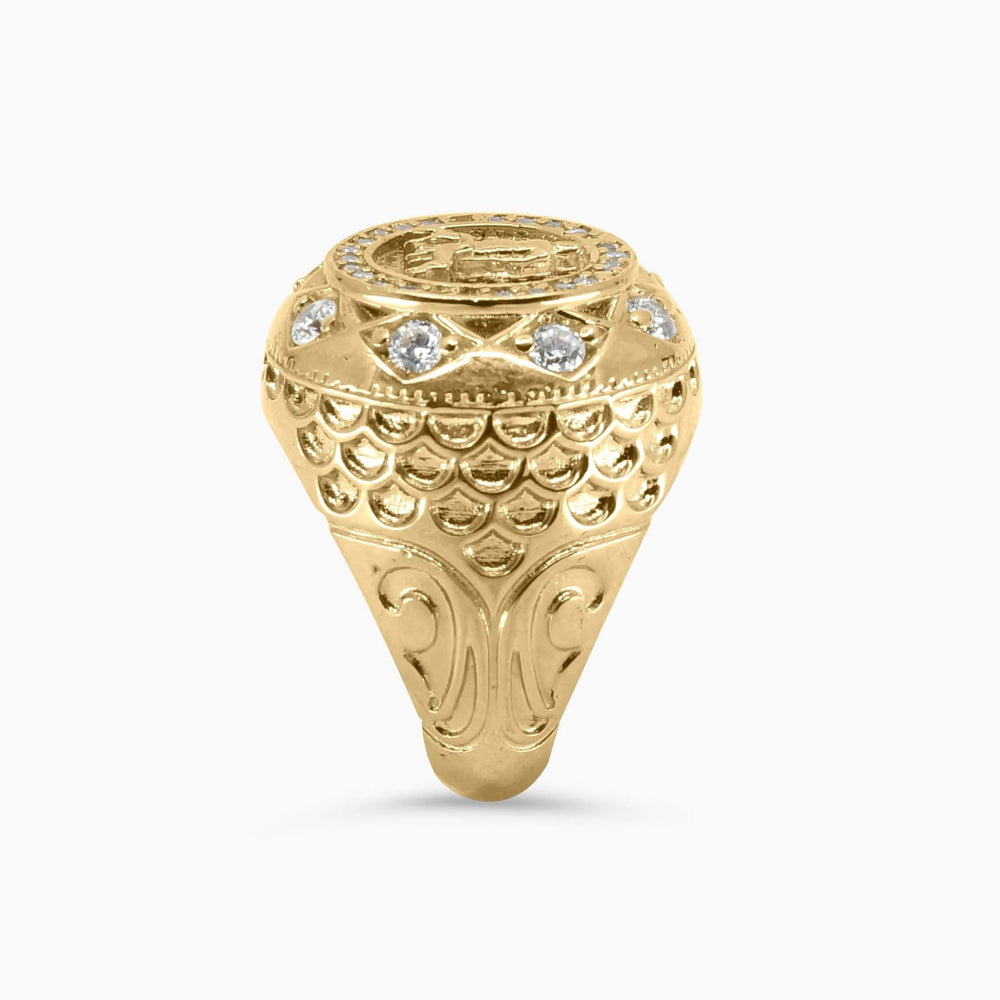 Gold ring with intricate design on a white background