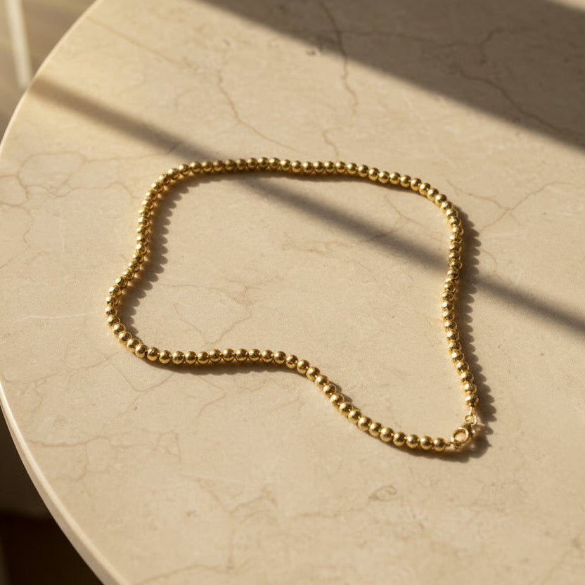 Gold chain bracelet on a white background