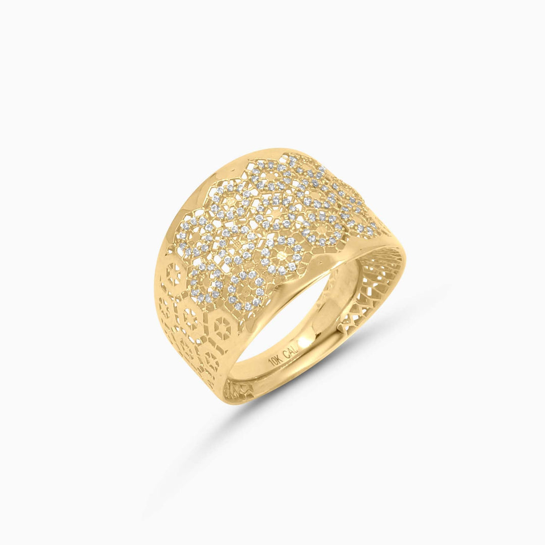 Gold ring with diamond-like stones on a white background