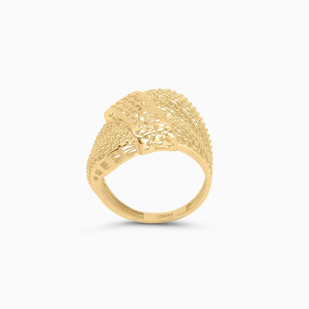 Gold ring with textured design on a white background