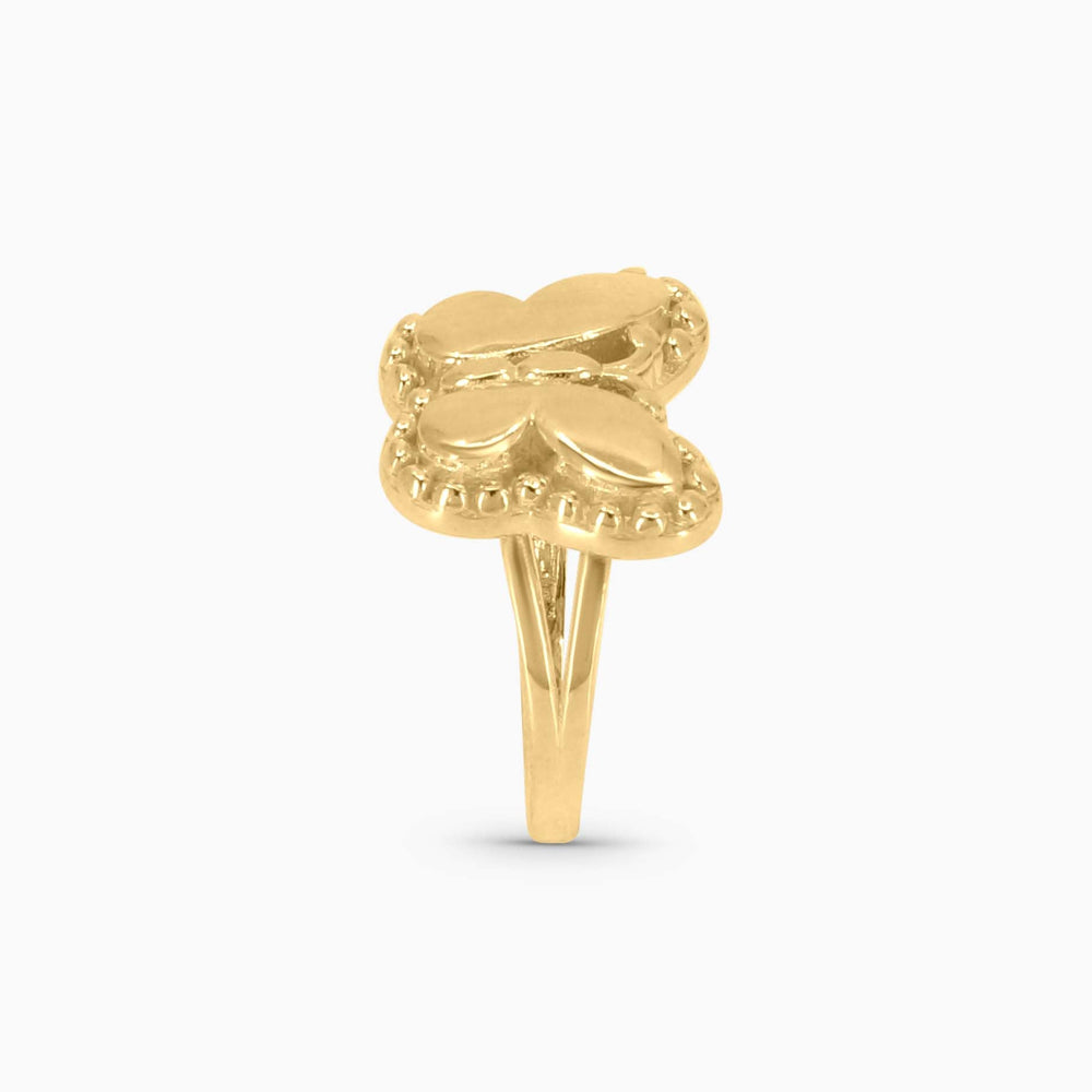 Gold ring with a heart design on a white background