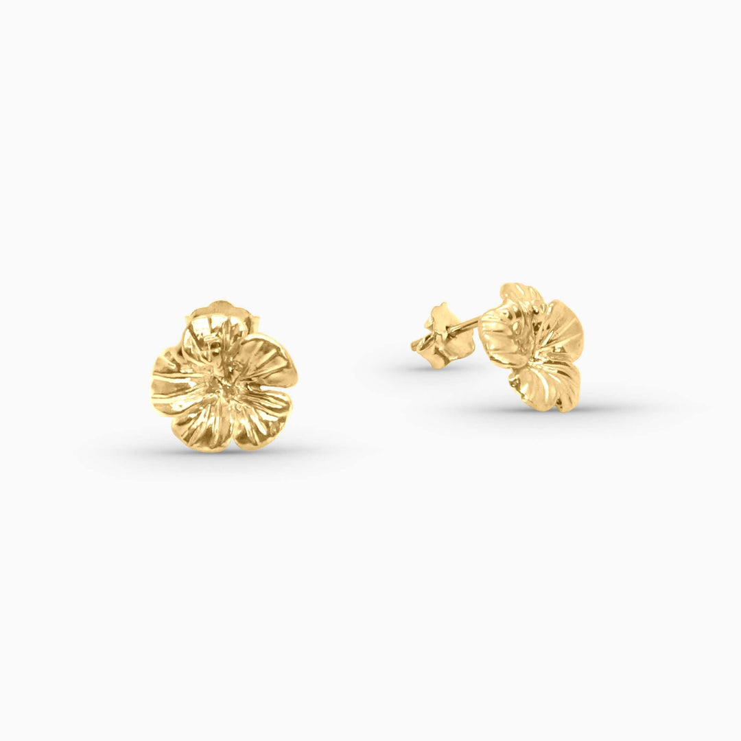 Gold floral stud earrings on a white background