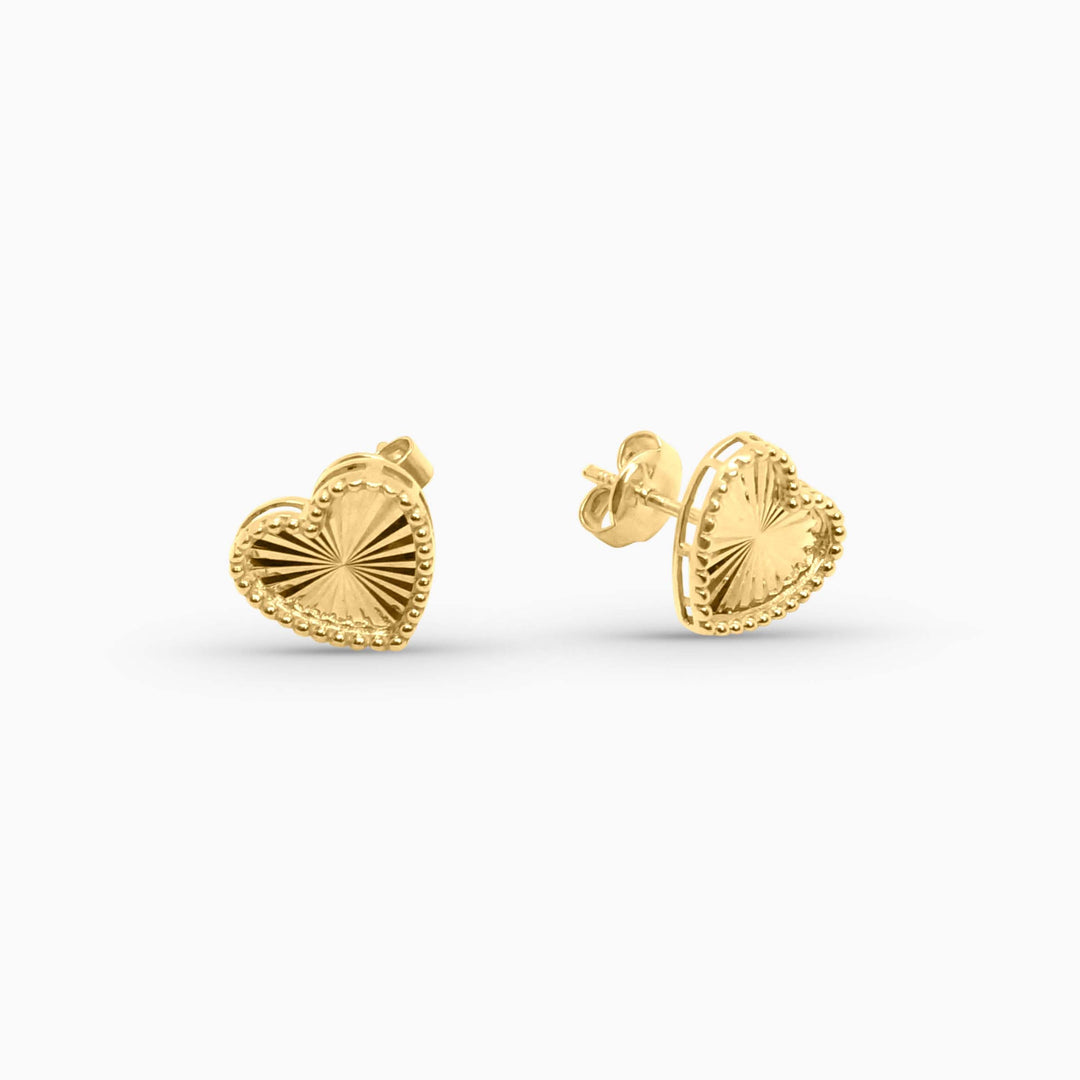 Gold heart-shaped earrings on a white background