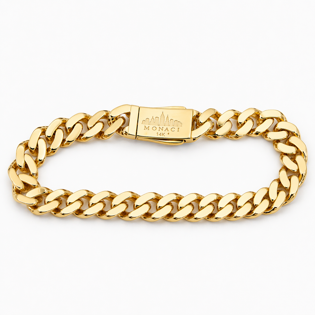 Gold chain bracelet with a visible brand logo on a white background