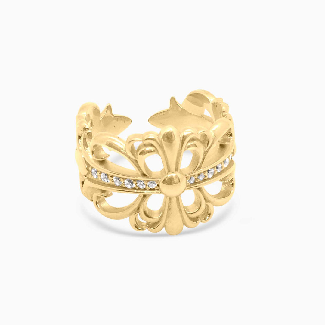 Gold ring with floral design and embedded stones on a white background