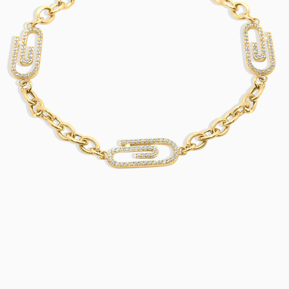 Gold chain necklace with unique links on a white background