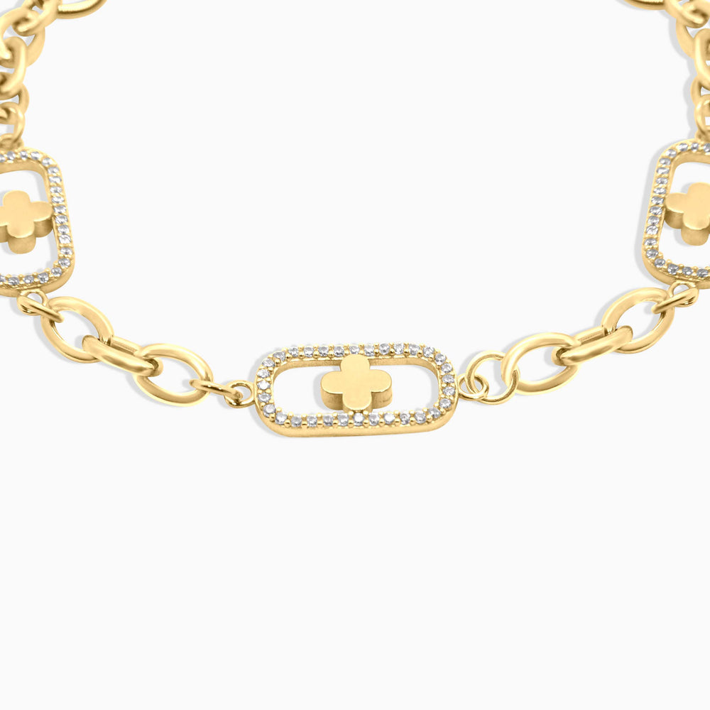 Gold bracelet with clover and chain design on a white background