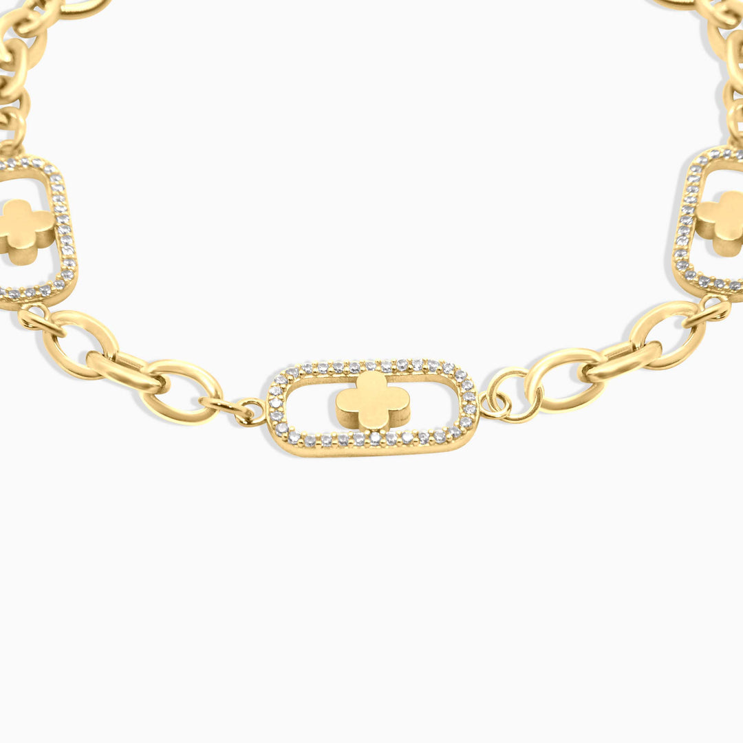 Gold bracelet with clover and chain design on a white background