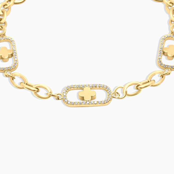 Gold bracelet with clover and chain design on a white background