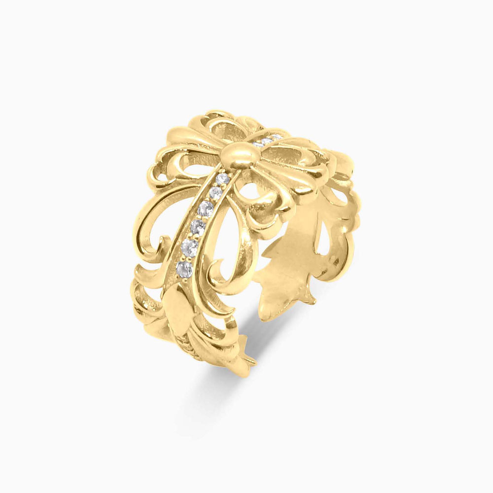 Gold ring with intricate design and small diamonds on a white background