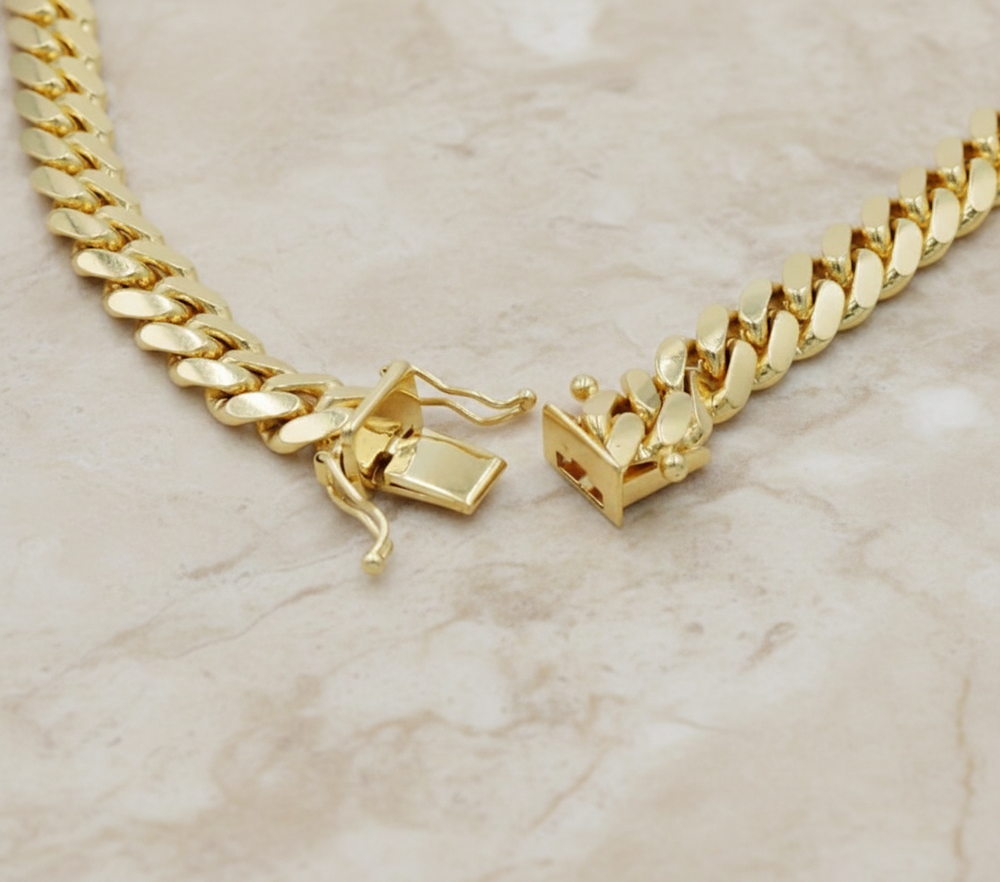 Gold chain necklace with a clasp on a white background