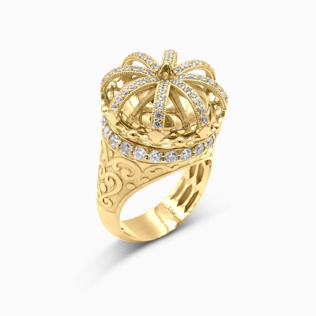 Gold ring with a crown design and diamond accents on a white background