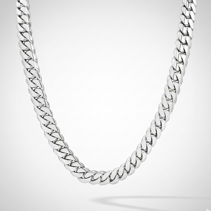 Silver chain necklace on a light gray background